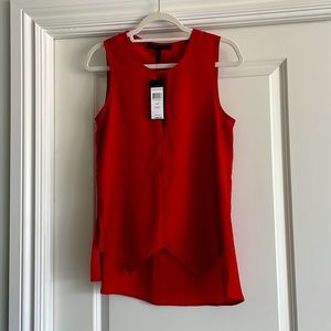 BCBG sleeveless top-handkerchief type bottom in the front & Longer in the back.